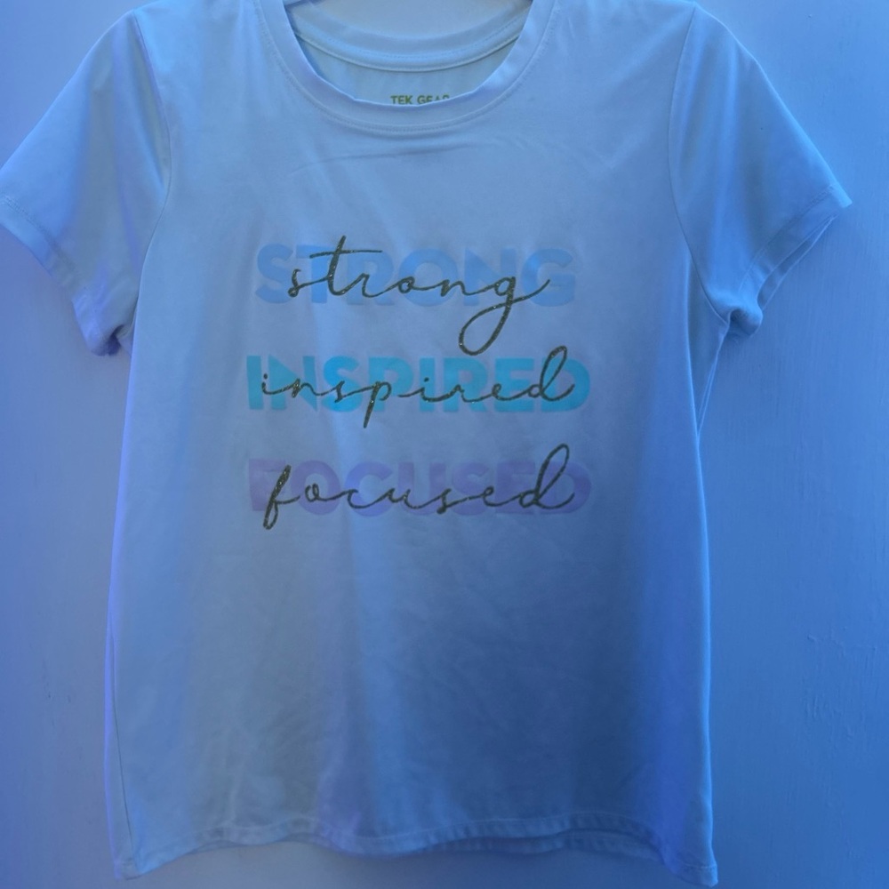 This is a kids size 10-12 white tech gear shirt that is used.